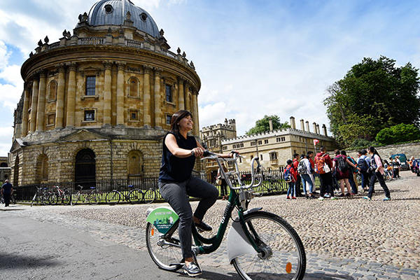 Image of cyclist riding around the Radcliffe camera